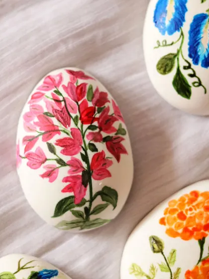 This marzipan Easter egg is decorated with delicate, freehand-painted bougainvillea flowers.