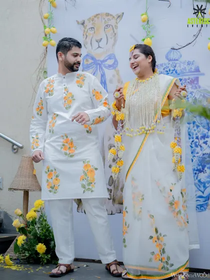 A happy couple at their Haldi ceremony. Their coordinated floral outfits perfectly complemented the cheerful, yellow-themed decor we designed for their special day.