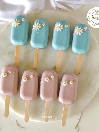 A throwback to some of my earlier cakesicle designs, featuring delicate daisy decorations in pink and blue.