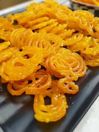 Crispy, hot jalebis served at a corporate Holi party. No festive celebration is complete without traditional sweets, and we make sure to include these favorites in our menus.
