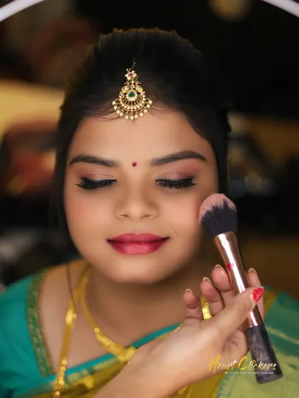 A close-up shot of the bride getting her makeup done. I focus on capturing the details of the bridal preparation process.