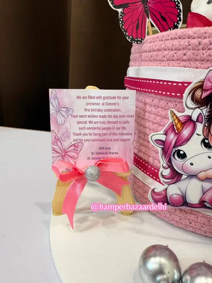 A close-up of the personalized thank you card for Simone's first birthday celebration.