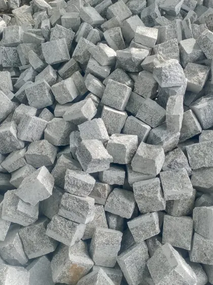 A large pile of light grey Sadahalli cobblestones, ready to be supplied for any project, big or small.