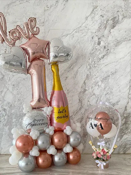 A perfect duo for a first anniversary celebration. I paired a large, custom balloon arrangement with one of my signature hot air balloon gifts, which held fresh flowers and chocolates.