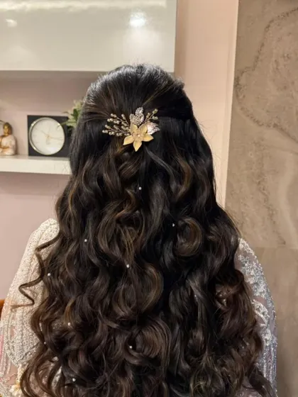 A detailed look at the elegant half-up hairstyle, adorned with a beautiful hair accessory. This style is perfect for keeping hair off the face while dancing.