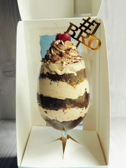 A slightly different angle of the Rakhi dessert, showing the depth of the layers within the elegant glass.
