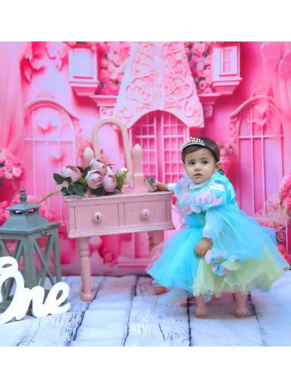 A Barbie-themed first birthday shoot with a glamorous pink backdrop and a little princess.