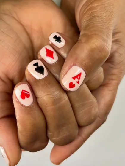 Ready for game night. This playful set features the four card suits, hearts, diamonds, clubs, and spades, each carefully painted on a short, square nail.
