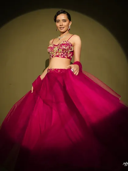 The flow of the fabric in this shot is beautiful. The makeup look is strong enough to hold its own, creating a powerful and elegant image.