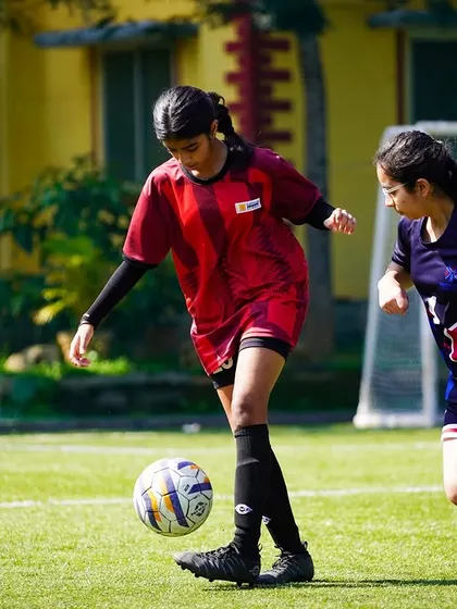 A player controls the ball with finesse, demonstrating her technical skill during the U-15 girls' inter-school championship.