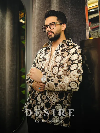 Another view of the crochet-style shirt, showcasing its unique pattern and the sophisticated attitude it projects.