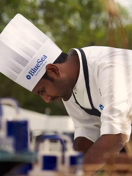 A chef meticulously prepares a dish for a corporate event in Agra. Our team's focus and dedication ensure that even at large scale events, every plate is perfect.