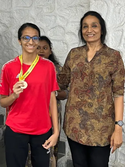 Another proud moment for Veyanka Daga, posing with her bronze medal. We support our shooters through every step of their competitive journey.