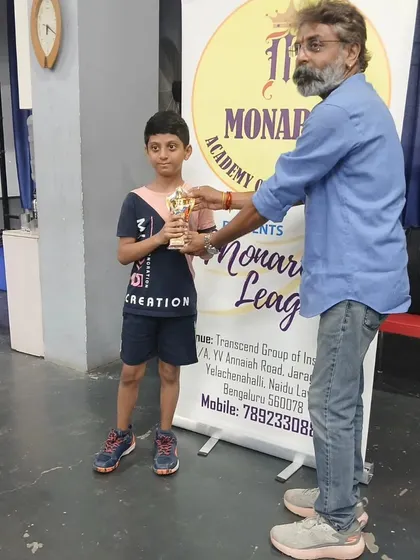 Siddanth receiving his trophy as the U11 Semi-Finalist at the 1st Monarch League, showing his consistent performance.