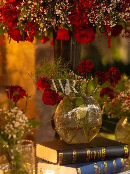 Details that tell a story. For this Sufi-themed event, I used stacks of old books and small arrangements of red roses to add a touch of vintage, poetic charm to the decor.