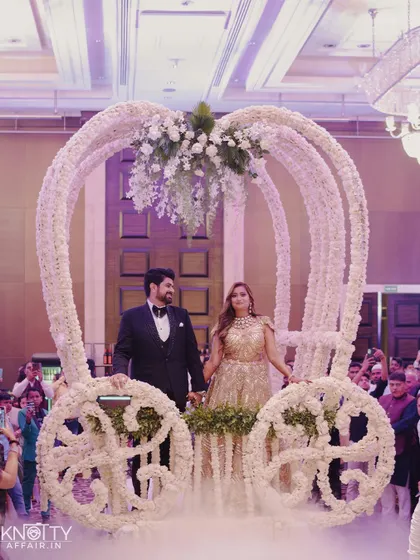 The couple's fairytale entrance in a flower-adorned carriage. We capture the grand, thematic elements that make your reception unique.