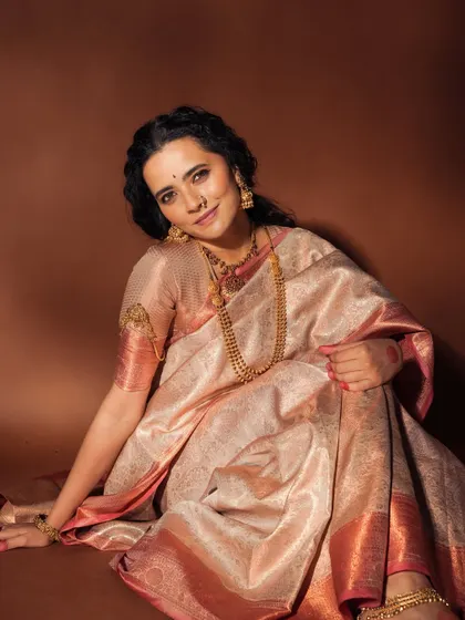 This image captures a relaxed and elegant pose. The makeup is kept natural and radiant, proving that you can look glamorous without heavy layers.