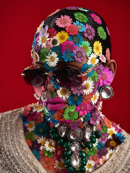 An extraordinary avant-garde concept where the model's face is covered in pressed flowers, creating a stunning and unique texture.