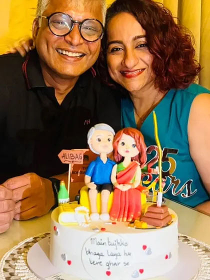 This cake tells the beautiful 25-year love story of a couple who eloped. We captured their journey with custom figurines and details representing their unique story, from their Catholic and South Indian backgrounds to where they first met.