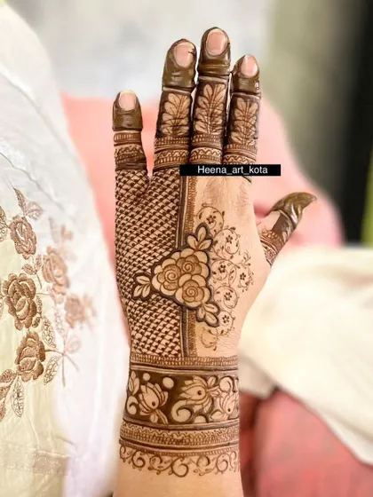 A lovely back-hand design that combines a central floral element with delicate net patterns, creating a balanced and beautiful look.