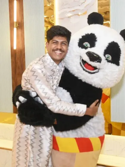A guest gives the panda mascot a big, happy hug.