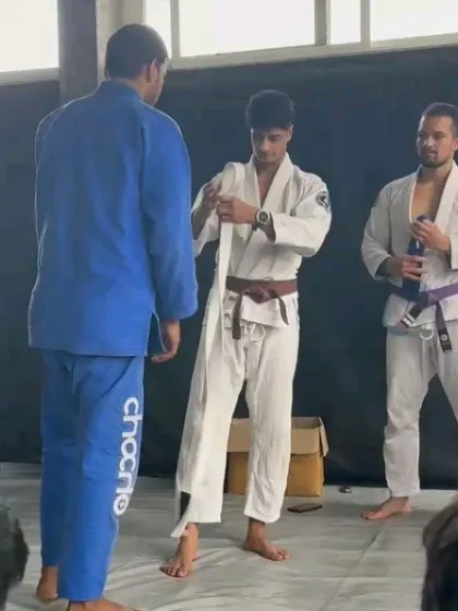 Receiving my blue belt from my head coach. This was a significant milestone in my Jiu-Jitsu journey, a result of consistent training and dedication.