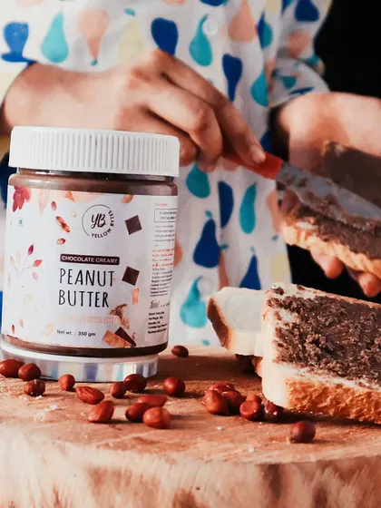 A lifestyle product shot showing the peanut butter being spread on bread. Including my son's hands adds a relatable, family-friendly touch that helps customers connect with the product on a personal level.