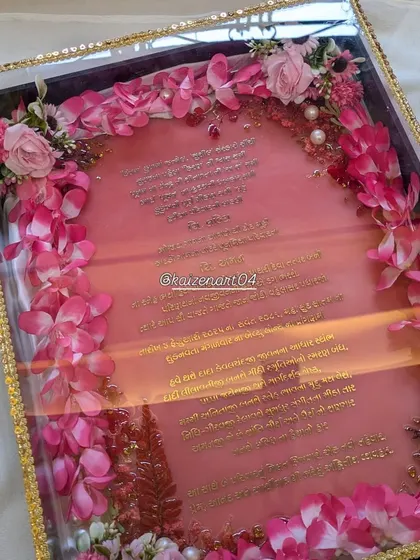 The beautiful pink resin Kankotri, with Gujarati text in a metal sticker, presented in a custom box. It’s an invitation that becomes a keepsake.