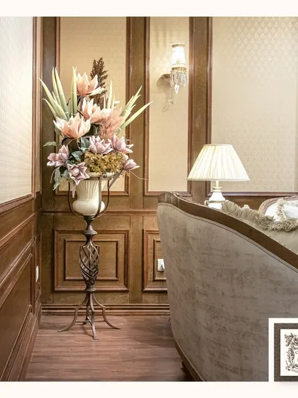 Here, an elegant floral display stands tall on a sleek metal pedestal. This arrangement is perfect for an entryway or a corner that needs a touch of dramatic, vertical beauty.