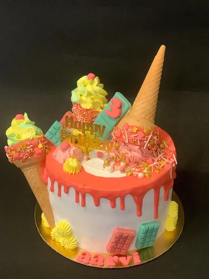 A colorful and fun "ice cream drip" cake. It's designed to look like melting ice cream and is topped with real cones and sprinkles.