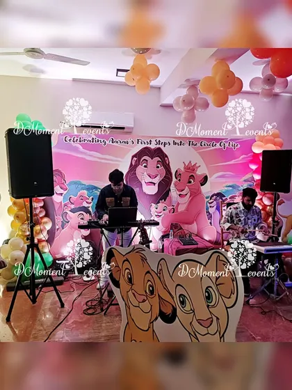 Live music adds a special touch to any celebration. For this Lion King party, I arranged for a live band to perform, complete with a keyboardist and guitarist, set against a themed backdrop.