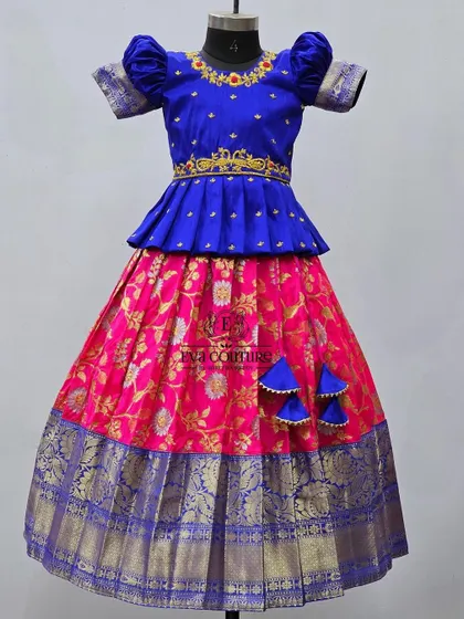 A mannequin view of the blue and pink lehenga, showcasing the detailed maggam work on the peplum top.