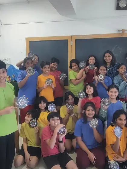A classroom full of students from the Inodai Waldorf School, each holding up the dot art coaster they created. This meditative activity is wonderful for helping children focus and express themselves.