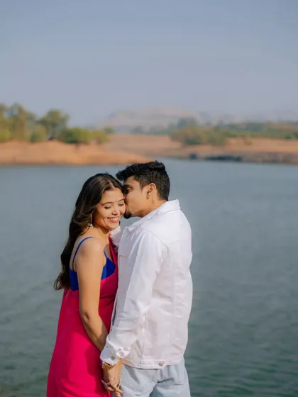 A sweet kiss on the forehead by the water's edge. This tender moment is a perfect example of the quiet romance we capture during our lakeside pre-wedding sessions.