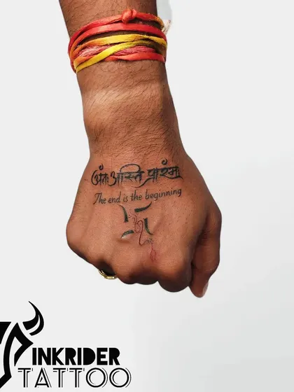 A different angle of the 'Ant asti prarambh' tattoo, this time on the hand, showing its versatility in placement.