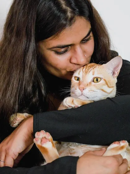 A color version of the tender moment between Akanksha and her cat, Jerry. The warmth of the light complements the warmth of the embrace.