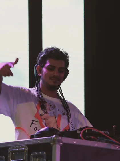 A shot of me behind the decks at a gig. This is where all the studio production comes to life, and I get to see the crowd's reaction to the tracks I've created.