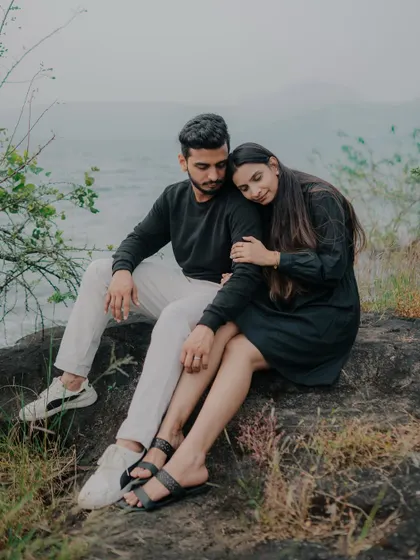 A quiet, tender moment by the lakeside. The moody lighting and natural setting create a serene and intimate atmosphere, perfect for capturing the couple's deep connection.