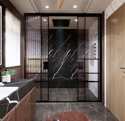 A bold and dramatic washroom design featuring black marble with striking white veins. The clean lines of the vanity and the sleek glass partition create a modern and sophisticated look.