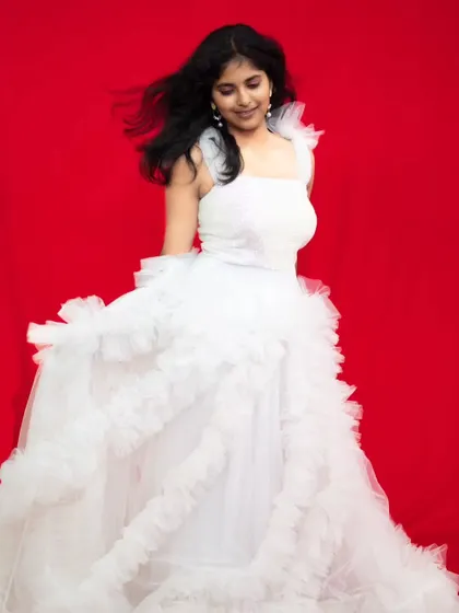 The movement of this white ruffle gown is captured beautifully in this studio photo.
