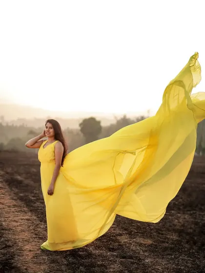 The long, flowing tail of this yellow gown is perfect for creating those dreamy, windswept shots during your pre-wedding photoshoot.