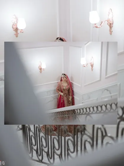 An artistic shot of the bride on the staircase, viewed through the railings for a creative frame.