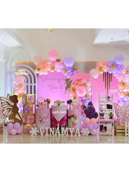 A fairy-themed birthday party with pink and purple decor.