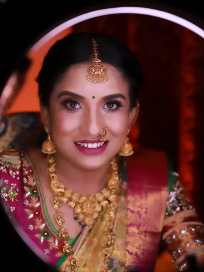 The final look for Rachana, captured in the glow of a ring light. The makeup is flawless, with a bright smile that shows her happiness.