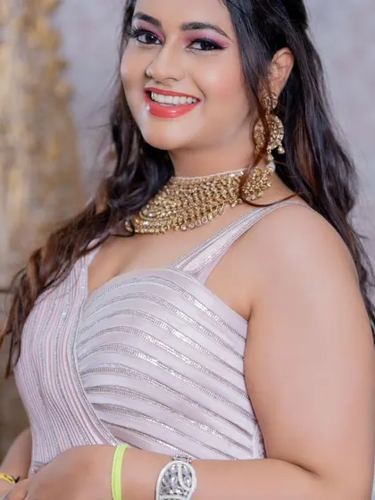 A happy, close-up shot of the model, highlighting the intricate gold choker that pairs perfectly with this rental gown.