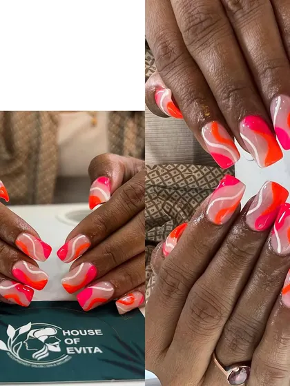 This is where your imagination comes to life. This set of custom nail art features a vibrant, abstract wave design in neon pink and orange. It shows my ability to work with bright colors and create unique, freehand patterns.