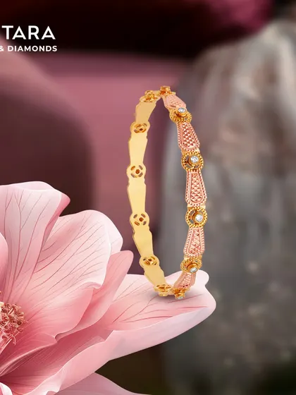 A closer look at the detailed craftsmanship of our rose gold and diamond bangle. The intricate patterns and pearl accents make it a timeless piece.