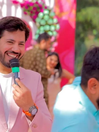 A happy, candid shot of me with the mic, enjoying the vibrant atmosphere of the Mehendi carnival.