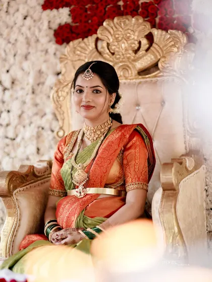 A regal portrait of a mom-to-be at her baby shower. The makeup is classic and elegant, with a soft gold eyeshadow and a warm lip color to complement her saree.
