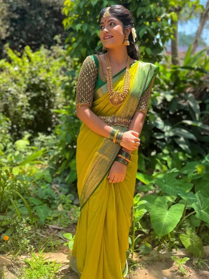 Another pose showing the full look of the lime green saree and the intricately beaded green blouse.